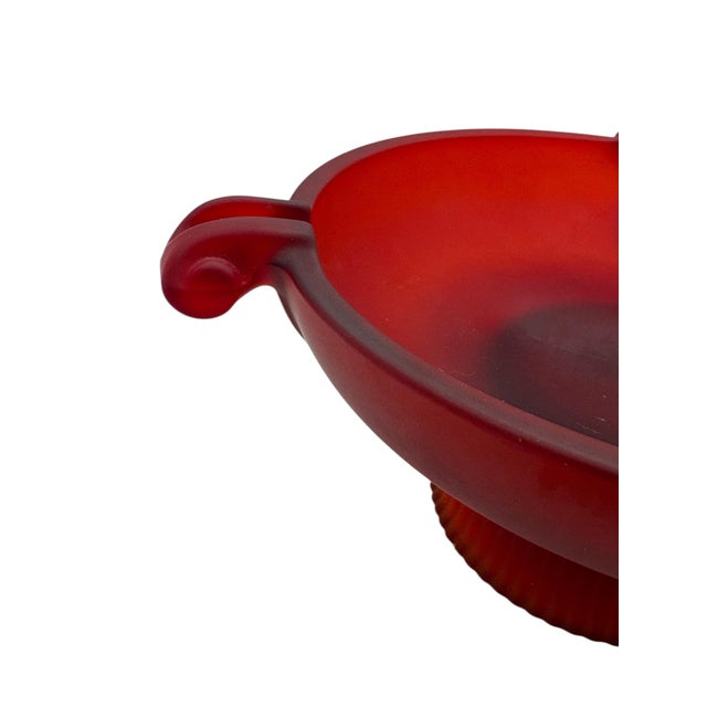 A Depression era red frosted glass footed ashtray, ca. 1930’s. It is executed in Art Deco style in a deep red color with...