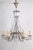 Rococo Revival waterfall crystal chandelier with six sweeping arms. Five tiers of icicle prisms at the center of the...