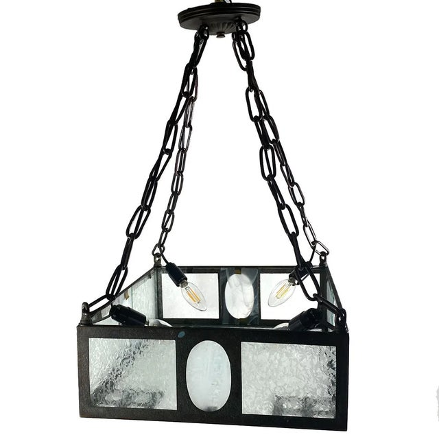 DETAILS An antique pendant light with a bronze chain and ceiling cap supporting an iron rectangular frame with colorless...