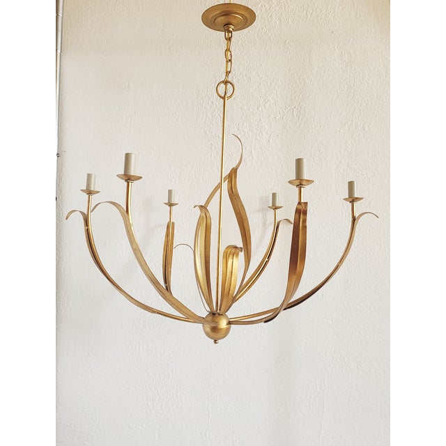 The Menefee chandelier by Currey & Company is graceful and elegant, Featuring slender leaves that swirl around the center...
