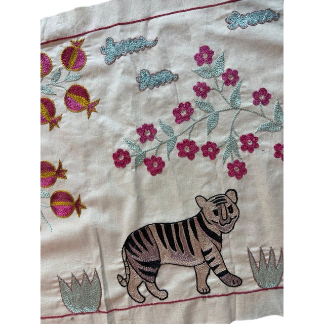 Hand-embroidered Suzani panel from Uzbekistan, worked in fine floss on a cream cotton ground. Three tigers move across the...