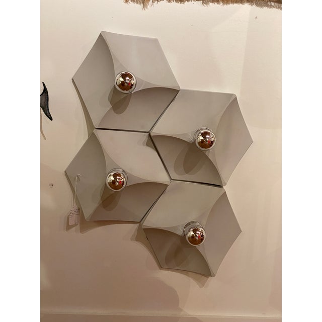 A modular wall installation of 4 sconces, produced by Hoffmeister in Germany during the 1960s. Each fixture is formed in...