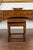 An English Georgian period oak table from the early 19th century, with lift top and turned base. Born in England during...
