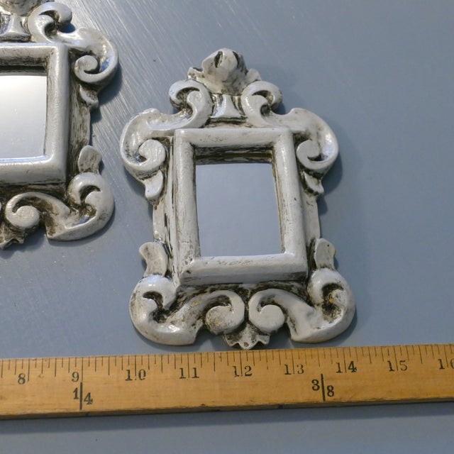 Pair of two small scale Rococo style rectangular mirrors featuring carved wood frames. Unusual pieces due to their size....