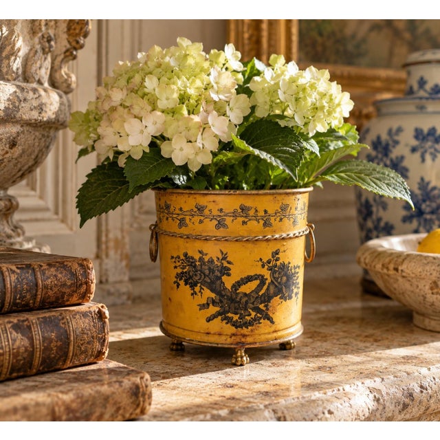 A wonderfully charming early 20th century Italian tole cachepot finished in yellow with delicate gilt embellishments and...