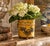 A wonderfully charming early 20th century Italian tole cachepot finished in yellow with delicate gilt embellishments and...
