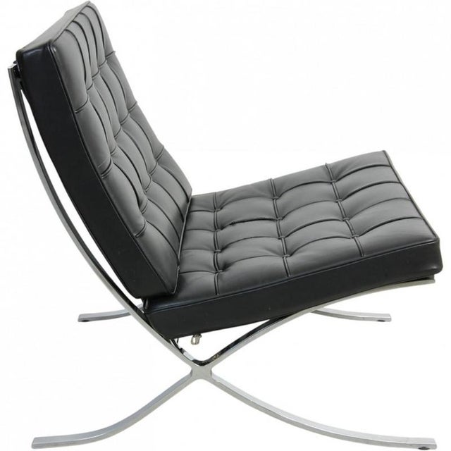 Ludwig Mies van der Rohe for Knoll Barcelona chair upholstered in black leather, and with a steel frame. The chair is from...