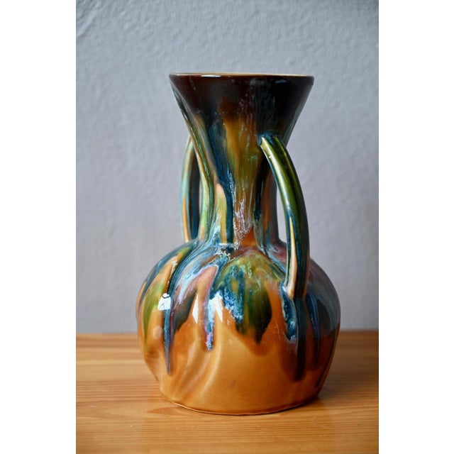 This captivating amphora-shaped vase in glazed ceramic perfectly captures the warm, creative spirit of the 1970s. Its...
