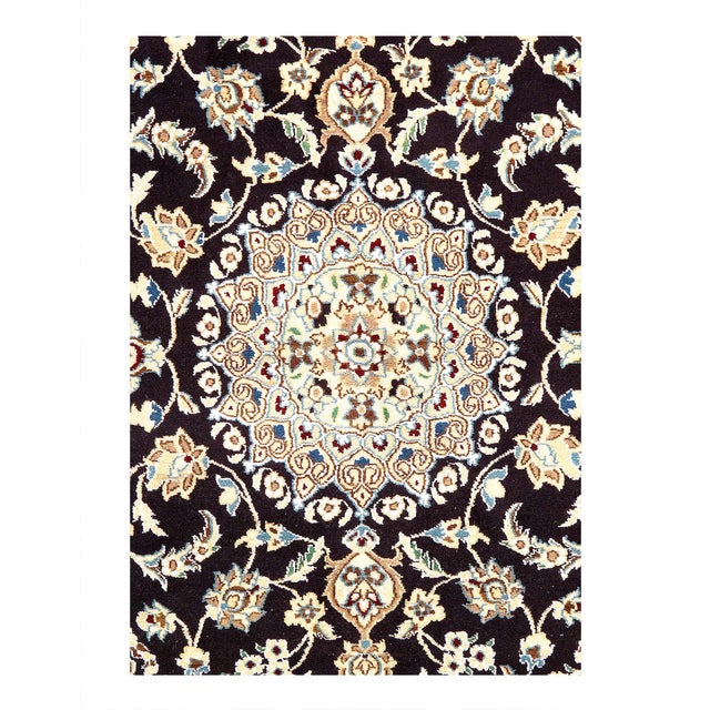 A hand-knotted, Nain rug that features gorgeous wool and silk and an ornate, tan and dark blue - ish field. D08132
