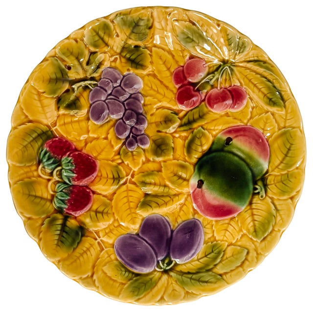 A Sarreguemines French faience round serving platter featuring a mixed fruit motif (strawberries, grapes, plums, cherries...