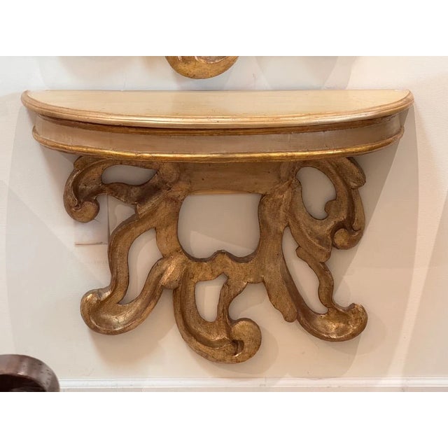 Fine Italian carved and gilded consoles, pair, having later tops over 18th Century fragments, attaching to a wall. H. 25”...