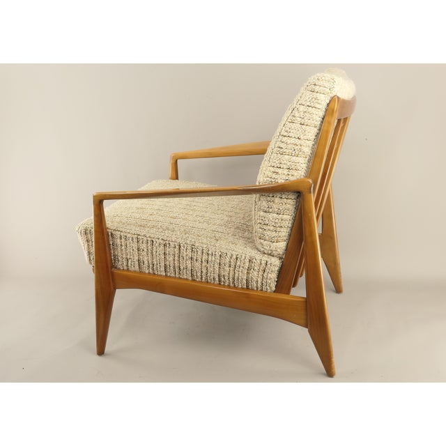 Mid-Century lounge chair made of solid oakwood, attributed to Eugen Schmidt. Features a dynamic design with integrated...