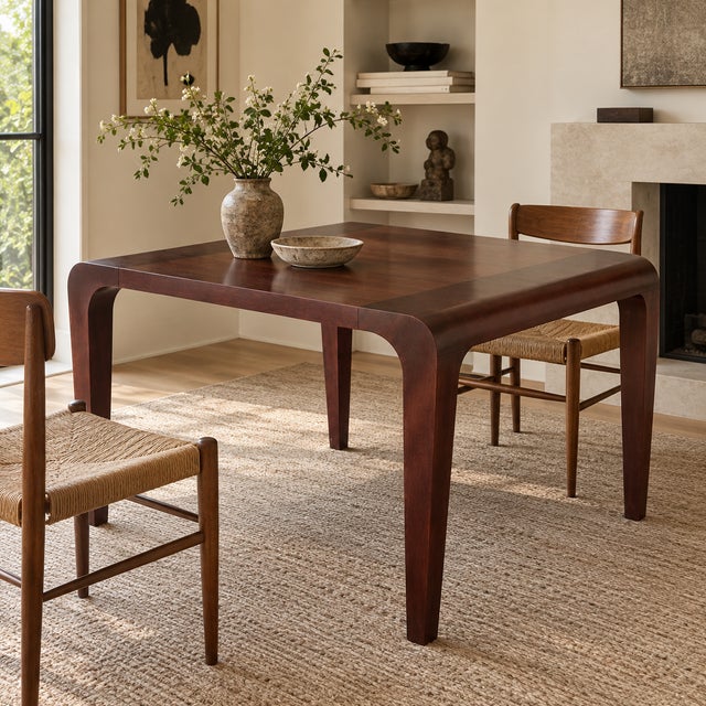 Sculptural square dining or game table by Alias, Italy, featuring a rich dark wood finish and beautifully curved edges...