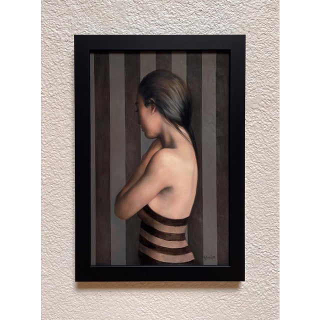 The artwork depicts a figure in profile, subtly shying away, enveloped in a muted palette of grays and earth tones....