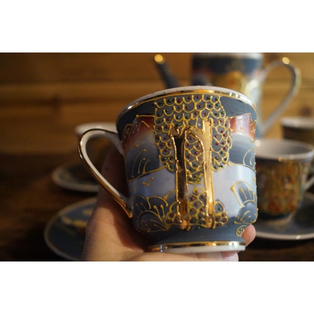 A fine Chinese version of a hand-painted porcelain Satsuma Moriage tea set, with gold detailing. There is a beautiful blue...