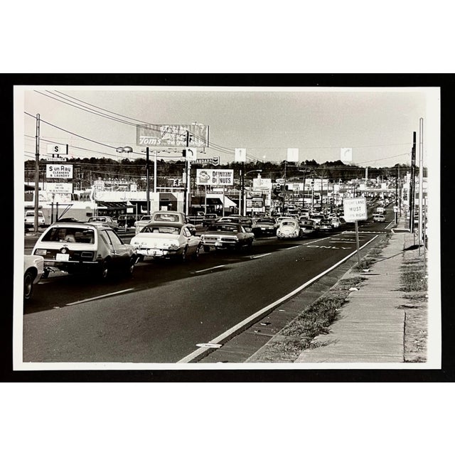 1975 b & w photograph of the traffic on Macon Road near the old Columbus Square Mall. The road has changed but the...