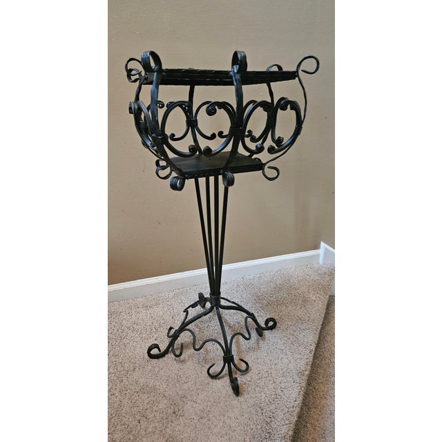 Mid century ornamental black iron plant stand. Very heavy and sturdy.