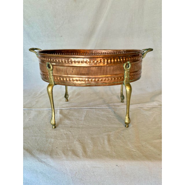 This Early 20th Century French Copper and Brass Jardiniere dates back to the early 1900's. The piece features an oval...