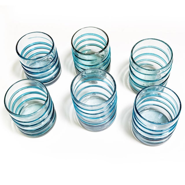 A beautiful set of six vintage hand-blown aqua blue drinking glasses featuring a substantial weight and distinctive...