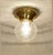Two Art Nouveau ceiling lamps, circa 1915. Bowl-shaped brass body. Clear glass shades with geometric cut-glass decoration....