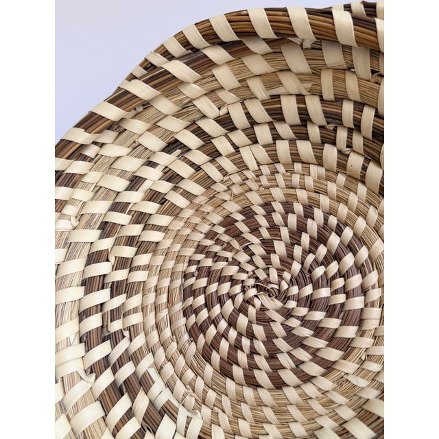 Handwoven Charleston sweetgrass basket in a classic shallow tray form, featuring a tightly coiled center and alternating...