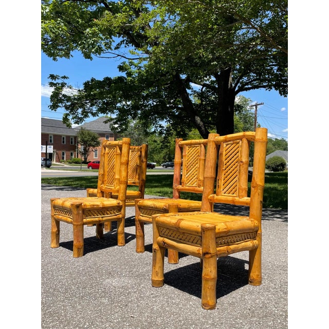 Set of four very solid and heavy handmade bamboo dining chairs. These unique chairs give off a 1970s vibe that would fit...