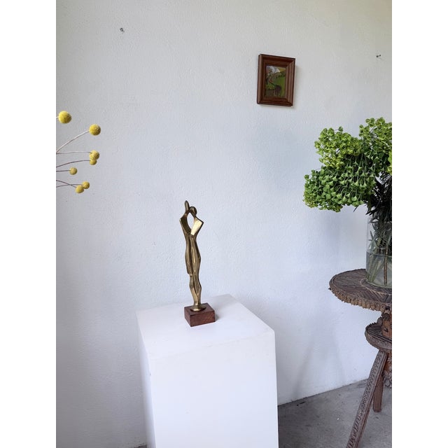 Antique bronze sculpture on its wooden base, depicting a couple. Inspired by Brancusi, this statue might remind one of the...