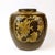 Beautiful brown and yellow ceramic pot that shows 4 intricate reliefs of birds and flowers.