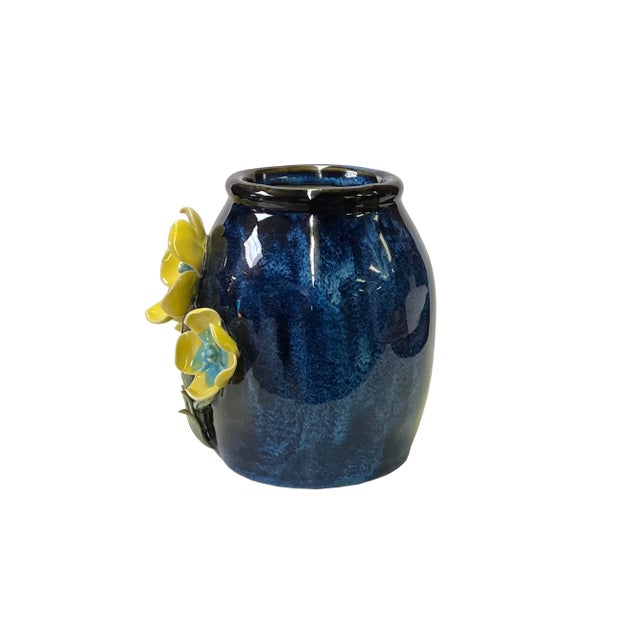 This is a Chinese decorative brush holder/pot in a navy blue color glaze finish. The theme is a dimensional colorful...