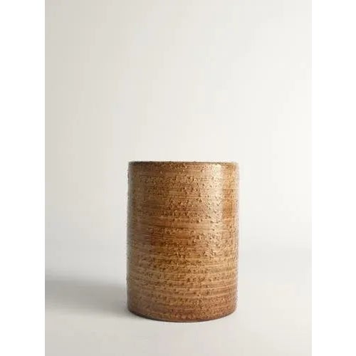This sturdy cylinder-shaped earthenware vase by the artist jerk werkmäster is a remarkable piece from nittsjö, sweden....