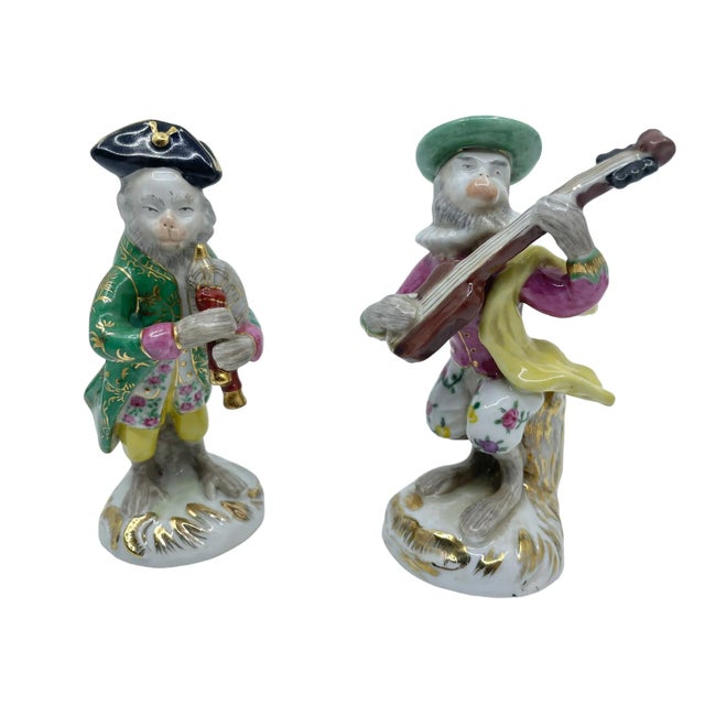 Vintage Monkey statues playing musical instruments. Beautiful array of colors and patterns. Monkeys wearing clothing and...