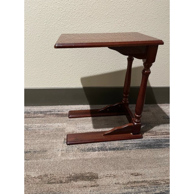 This is a small wooden lacquered tray table, like a TV tray with legs to fit under a couch. The tray features spindle-like...
