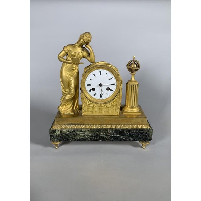 Empire or Directoire period clock depicting a woman reading, 19th century For Sale
