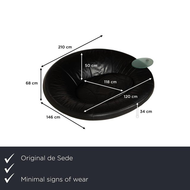 The DS 152 sofa from de Sede is upholstered in black leather and rests on silver metal legs. Its organic design and...