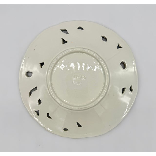 This beautiful 8" reticulated plate is one of five in our collection, each with a unique floral majolica painting with...