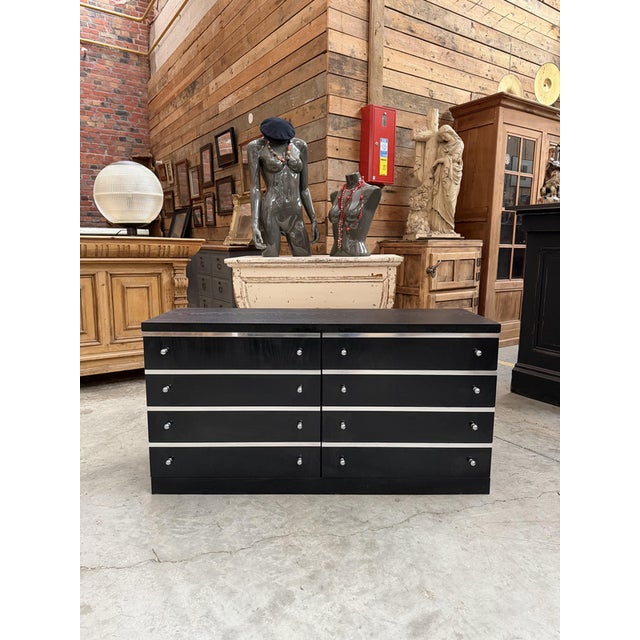 Low black cabinet with 8 functional drawers, enhanced with stainless steel finishes and handles. Ample storage capacity,...