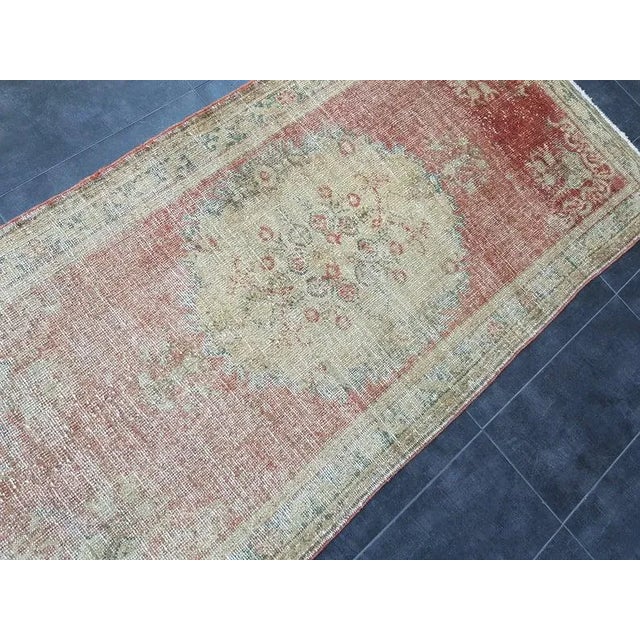 This is a vintage Turkish Oushak rug from the 1960s. The piece was hand-knotted.