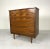 A stunning and rare sculptural highboy dresser by United with beautiful carved eye-shaped drawers. There are four drawers...