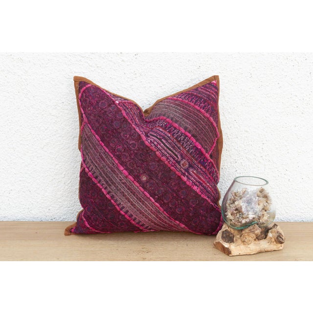 This 14-inch square pillow is a breathtaking fragment of Rajasthani heritage, repurposed from antique Banjara textiles...