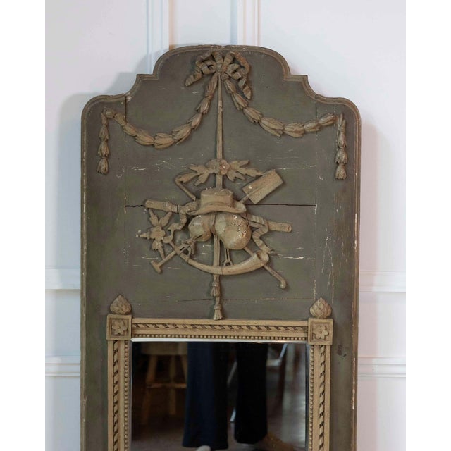 A beautiful French trumeau mirror dating to the Louis XVI period of the late 18th century. Retaining its elegant grey-...