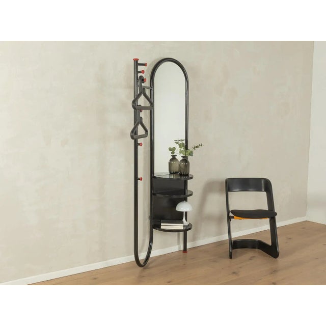 Postmodern coat rack by Schönbuch from the 1970s. Black lacquered metal frame with a mirror and three shelves. Made in...