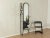 Postmodern coat rack by Schönbuch from the 1970s. Black lacquered metal frame with a mirror and three shelves. Made in...
