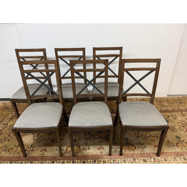 Design Plus Gallery presents a Set of Six Cross-Back Dining Room Side Chairs. They have a style that is attributed to...