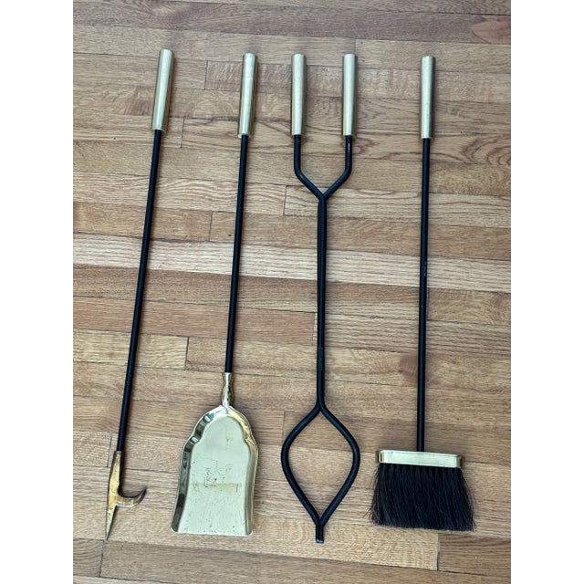 Striking mid-century modern fireplace tool set attributed to George Nelson. This four-piece set includes a poker, shovel,...
