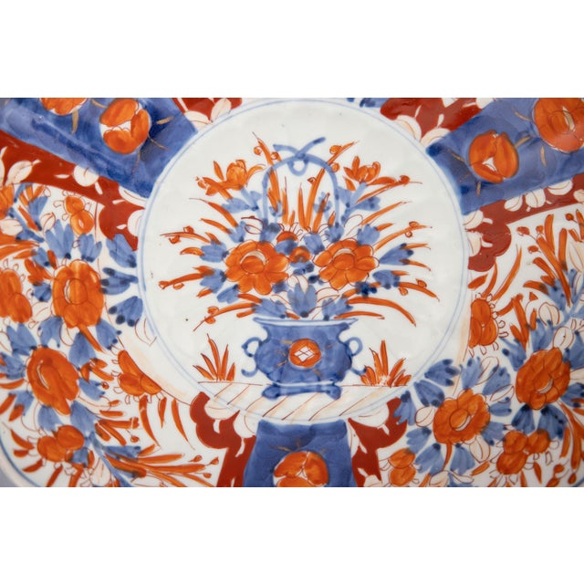 A gorgeous 19th-Century Japanese Meiji Period Imari porcelain charger with a hand painted floral design in the traditional...