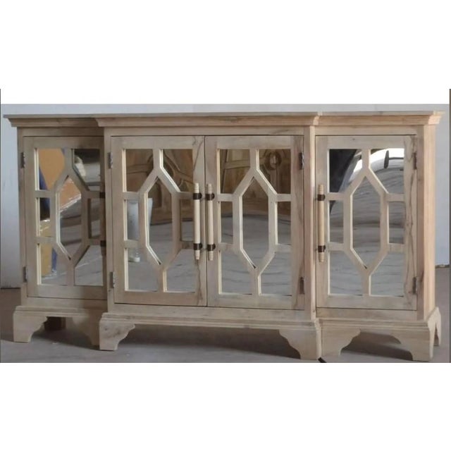 This Coastal entryway credenza features carved solid wood and mirror doors, offering a tall breakfront sideboard or media...