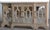 This Coastal entryway credenza features carved solid wood and mirror doors, offering a tall breakfront sideboard or media...