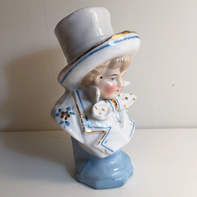 Charming bust of a rosy-cheeked young boy wearing a very large hat. In great condition with no chips or nicks. Blue and...