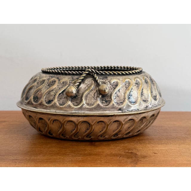 Small 1980s planter cachepot in silverplate over brass with rope trim detail around the lip. A pretty vessel for your...