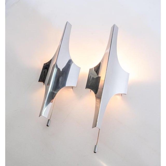 Elegant pair of nickel-plated wall lights designed by wilhelm braun-feldweg. An absolute eye catcher made of metal with a...